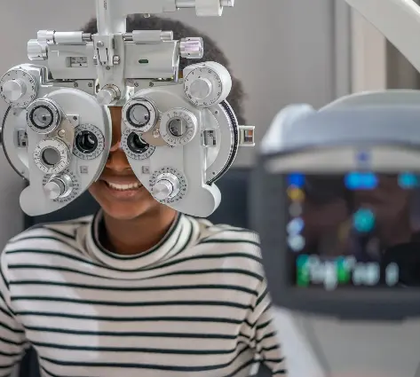 A person with an eye test device in front of them.